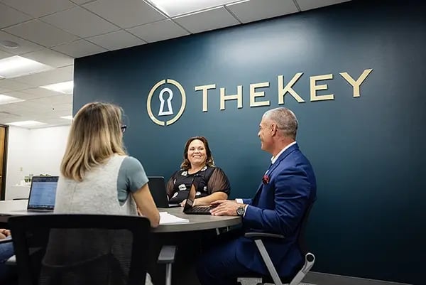 TheKey senior care advisors consulting with a family in a TheKey office, providing personalized home care guidance and support