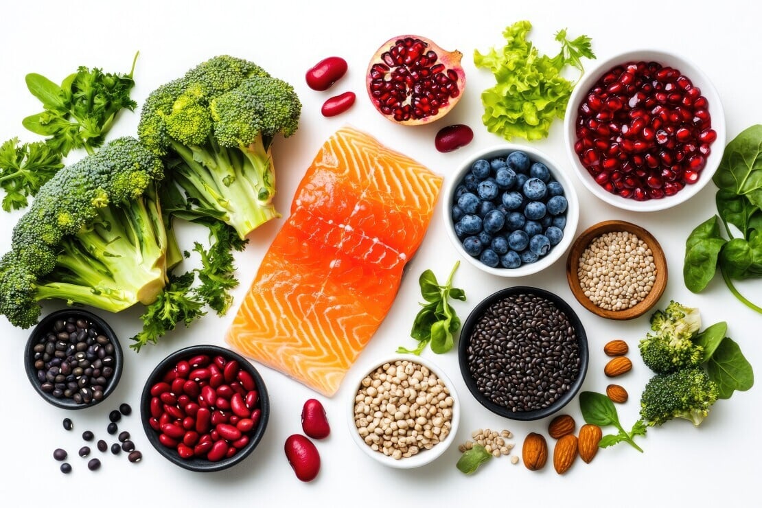 Anti-inflammatory foods including salmon, blueberries, broccoli, pomegranate, and leafy greens to support senior health